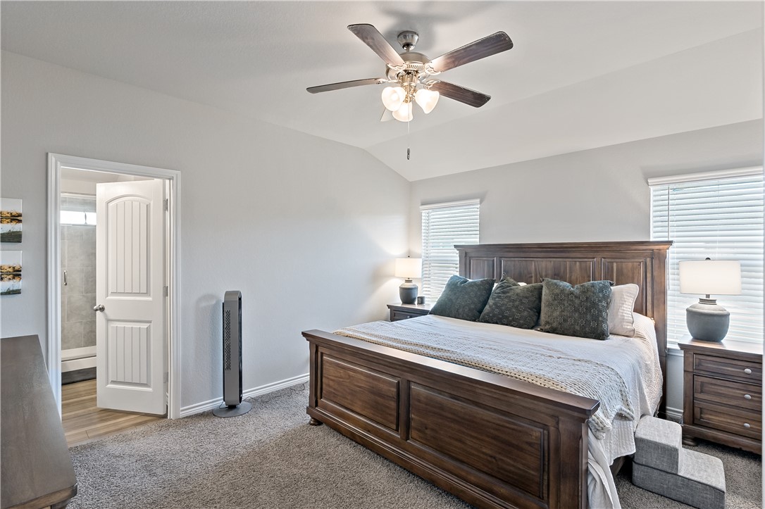 2135 Chief Street Bryan, TX 77807 - Photo 15 of 26 a bedroom with a bed and a chandelier