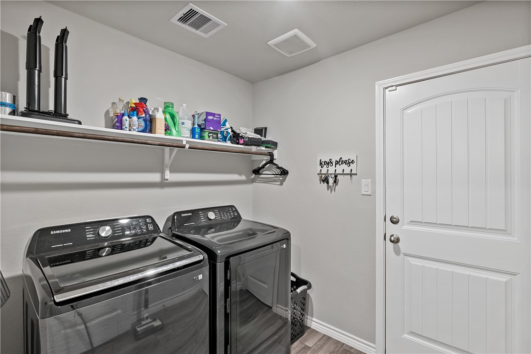 2135 Chief Street Bryan, TX 77807 - Photo 21 of 26 a view of storage and utility room with washer and dryer