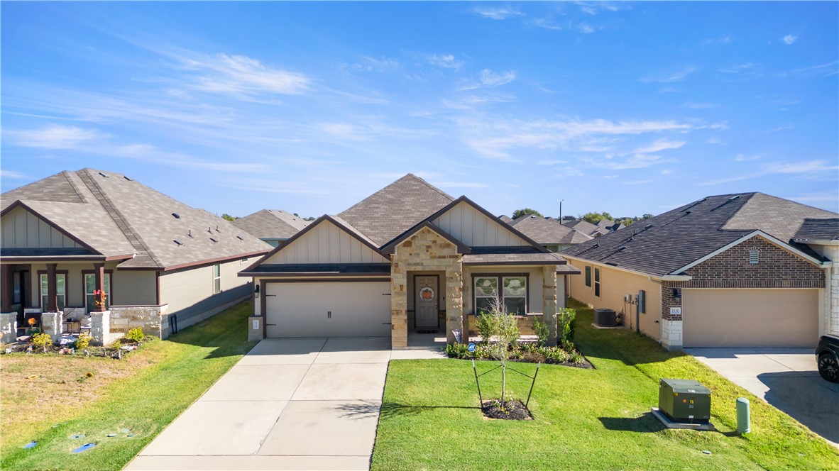 2135 Chief Street Bryan, TX 77807 - Photo 25 of 26 a front view of a house with a yard table and chairs