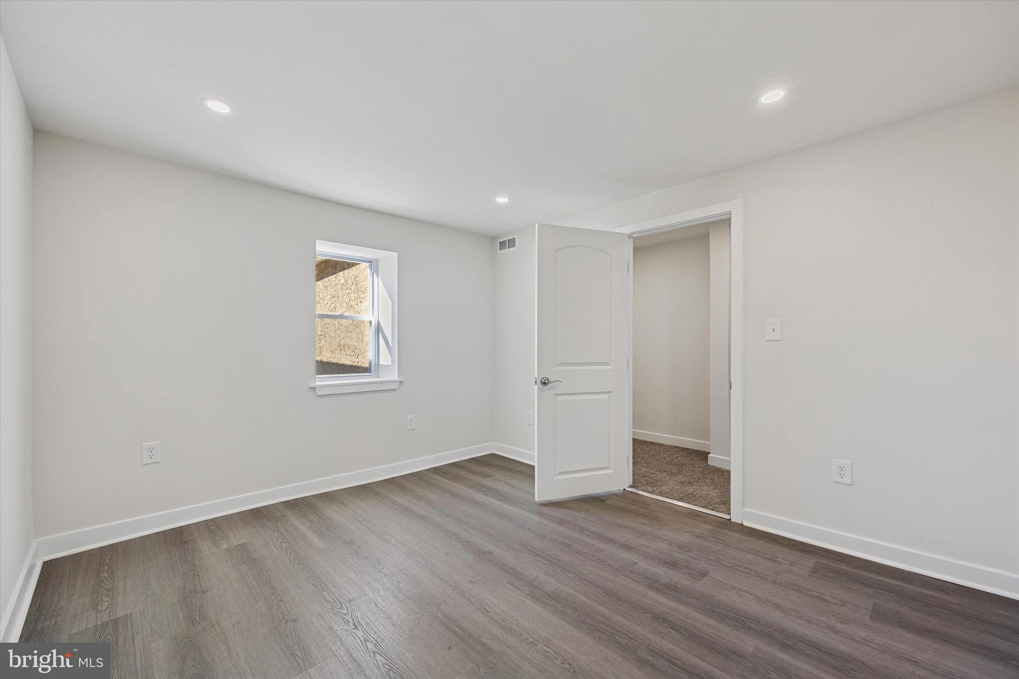 4666 Canton Street Philadelphia, PA 19127 - Photo 19 of 35 a view of an empty room with wooden floor and a window