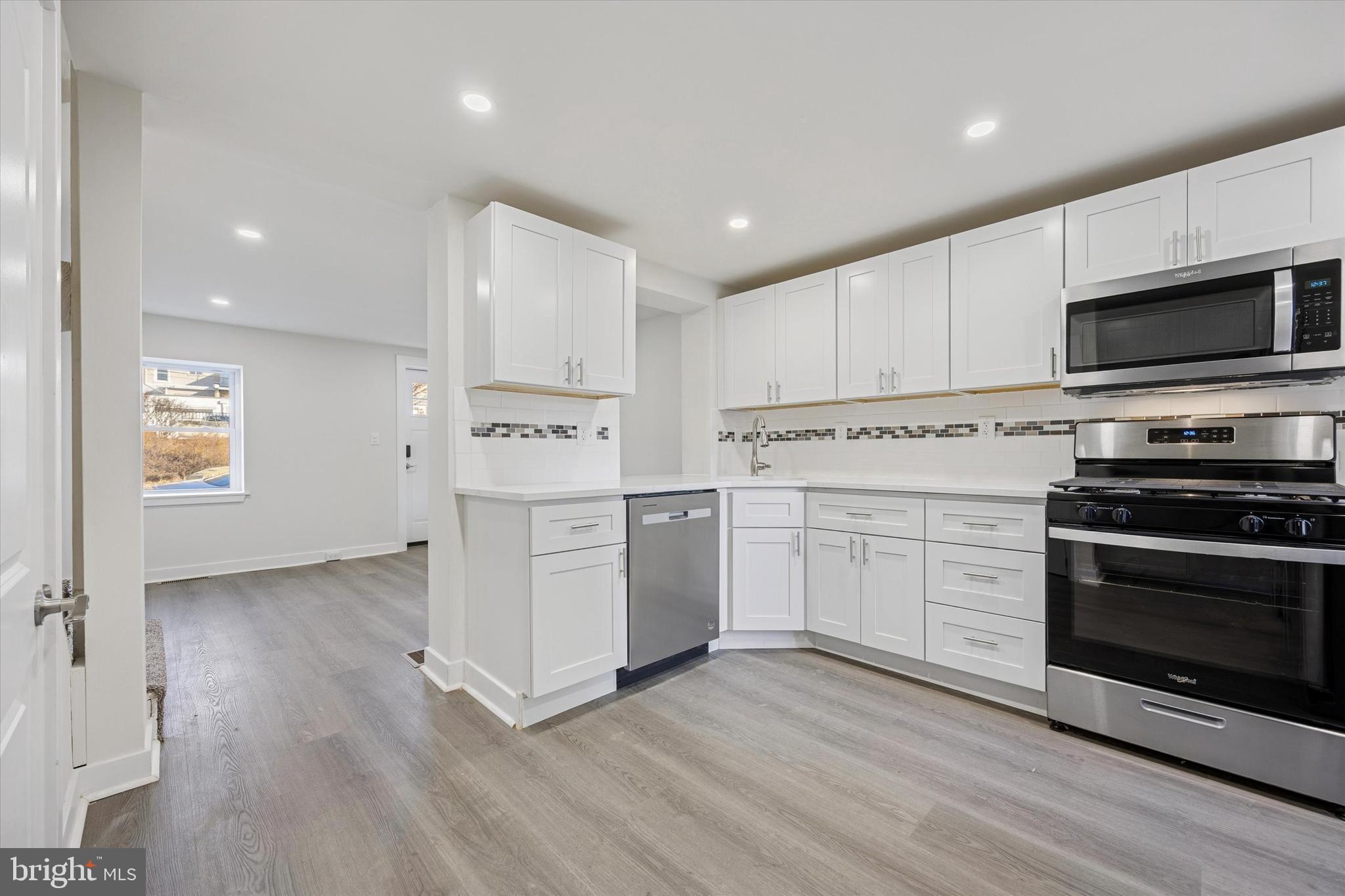 4666 Canton Street Philadelphia, PA 19127 - Photo 6 of 35 a kitchen with cabinets stainless steel appliances and wooden floor