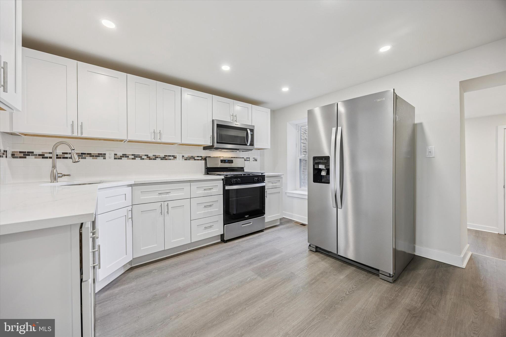 4666 Canton Street Philadelphia, PA 19127 - Photo 7 of 35 a kitchen with stainless steel appliances a refrigerator sink and white cabinets