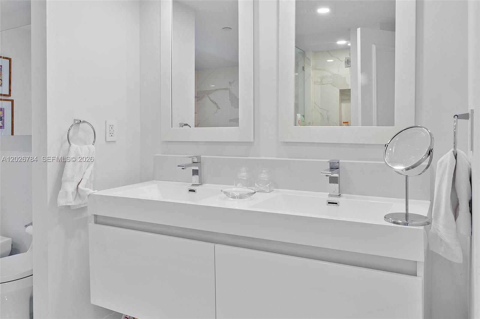 151 Southeast 15th Road, Unit 601 Miami, FL 33129 - Photo 24 of 36 a bathroom with a sink and a mirror