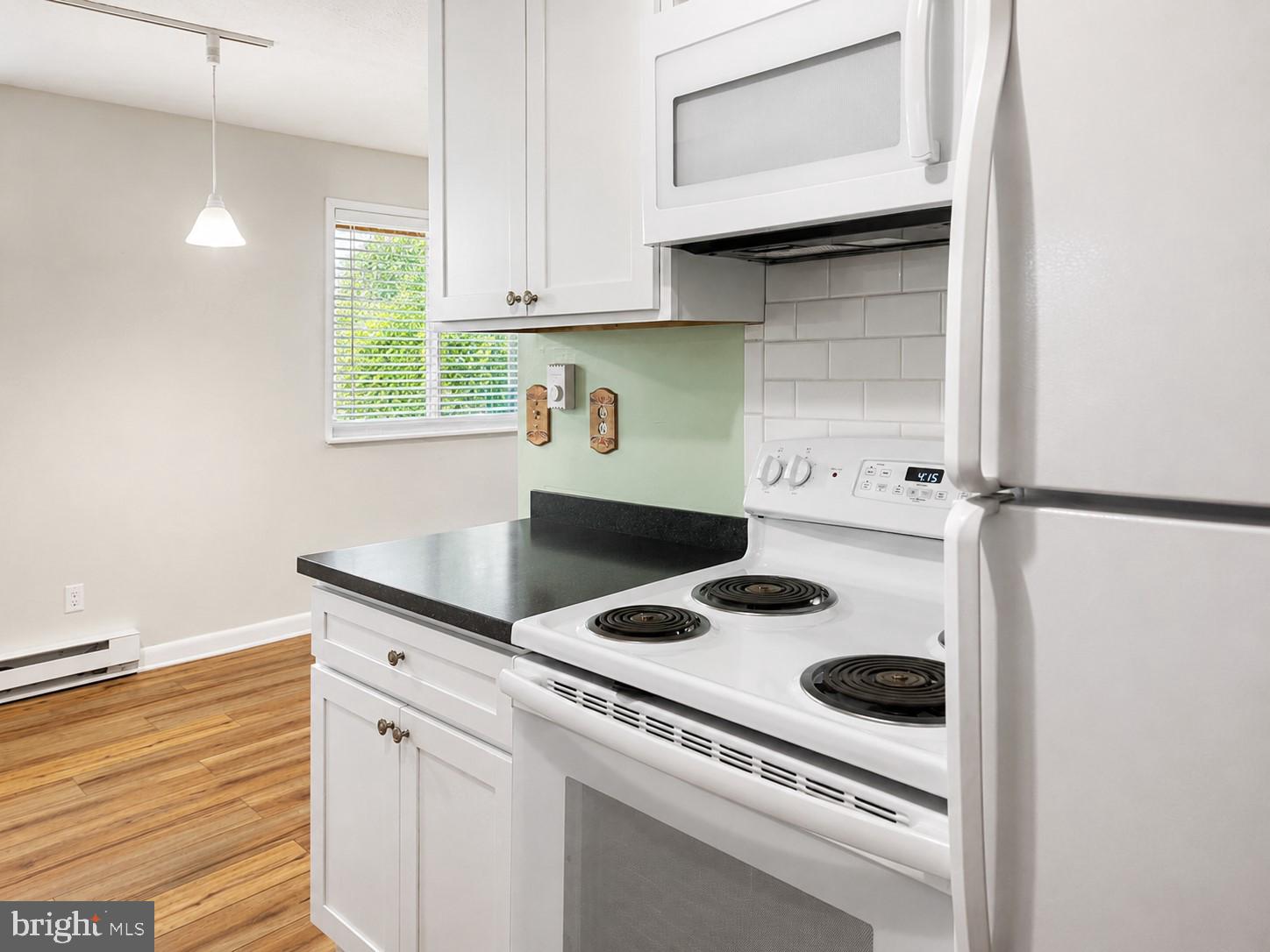 1724 Mosser Road, Unit 11 McHenry, MD 21541 - Photo 10 of 24 a kitchen with a stove cabinets and a window