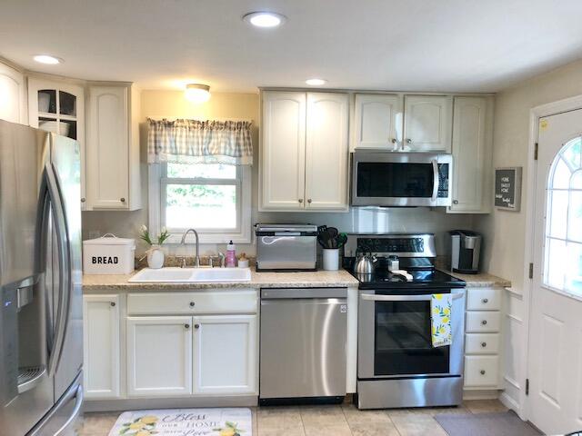75 Tanbark Road Marstons Mills, MA 02648 - Photo 3 of 40 a kitchen with a sink stove and refrigerator