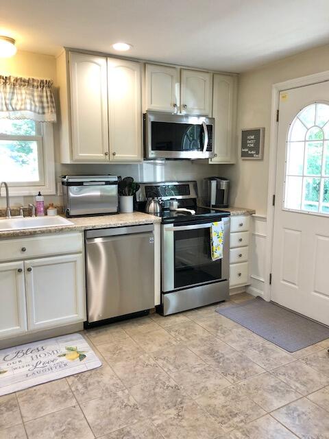 75 Tanbark Road Marstons Mills, MA 02648 - Photo 8 of 40 a kitchen with white cabinets stainless steel appliances and sink