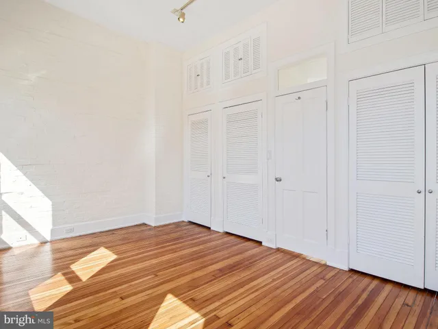 a view of a room with wooden floor
