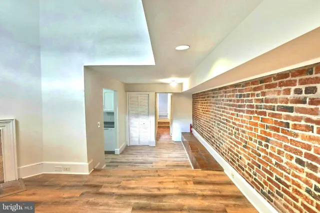 a view of a room with wooden floor