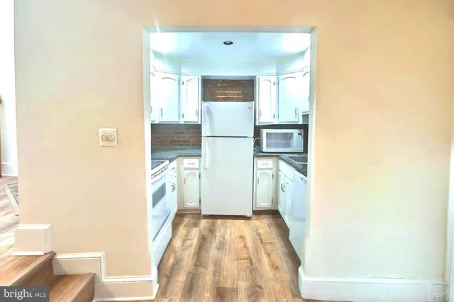 a bathroom with a bathtub and a hallway