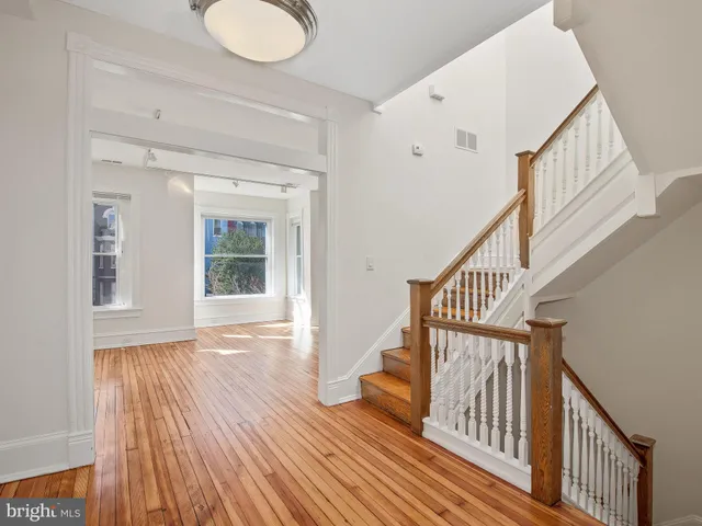 a view of an entryway with wooden floor