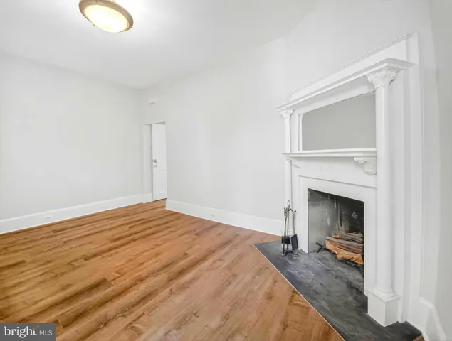 a bedroom with a bed and a fireplace