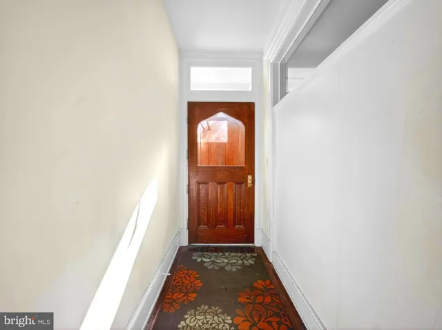 a view of hallway with wooden floor