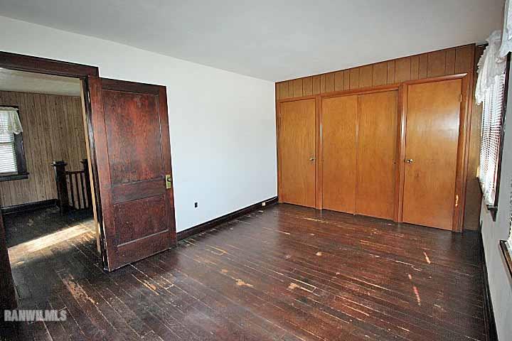 898 North Henderson Road Freeport, IL 61032 - Photo 13 of 19 a view of an empty room with wooden floor and a window