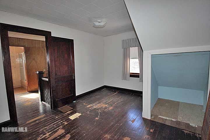 898 North Henderson Road Freeport, IL 61032 - Photo 16 of 19 a view of an empty room with wooden floor and a window
