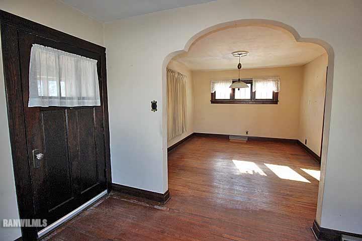 898 North Henderson Road Freeport, IL 61032 - Photo 3 of 19 an empty room with wooden floor cabinet and windows