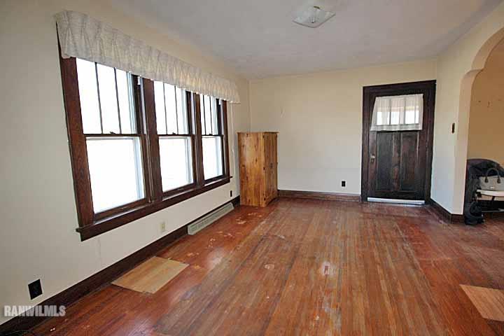 898 North Henderson Road Freeport, IL 61032 - Photo 4 of 19 a view of empty room with wooden floor and fan