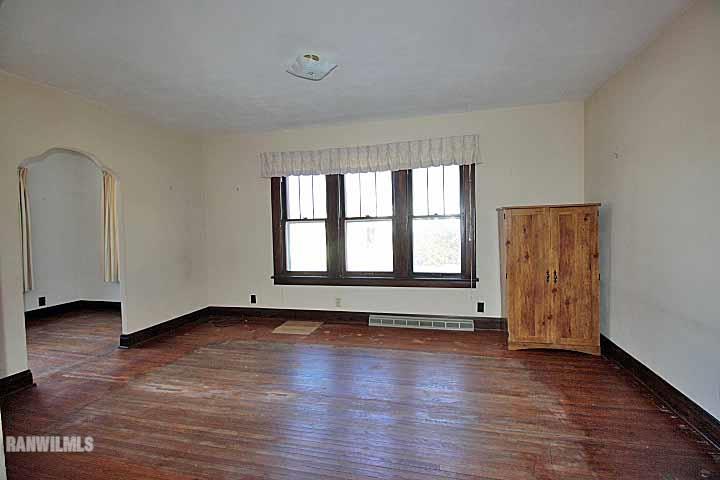 898 North Henderson Road Freeport, IL 61032 - Photo 5 of 19 an empty room with wooden floor and windows
