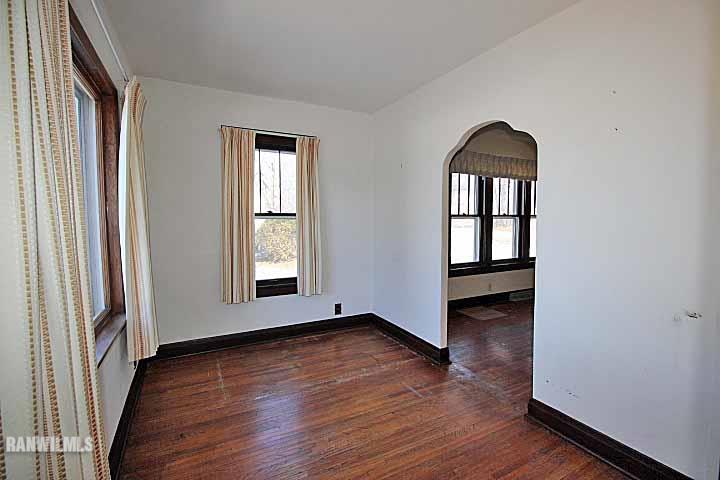 898 North Henderson Road Freeport, IL 61032 - Photo 8 of 19 an empty room with wooden floor and windows