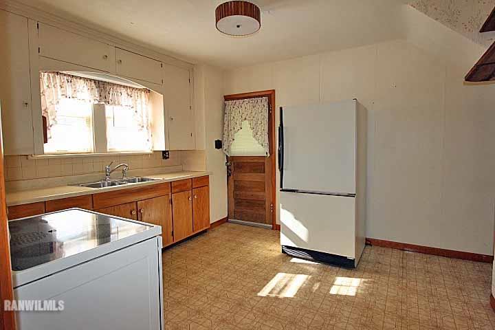 898 North Henderson Road Freeport, IL 61032 - Photo 9 of 19 a kitchen with a refrigerator and a sink