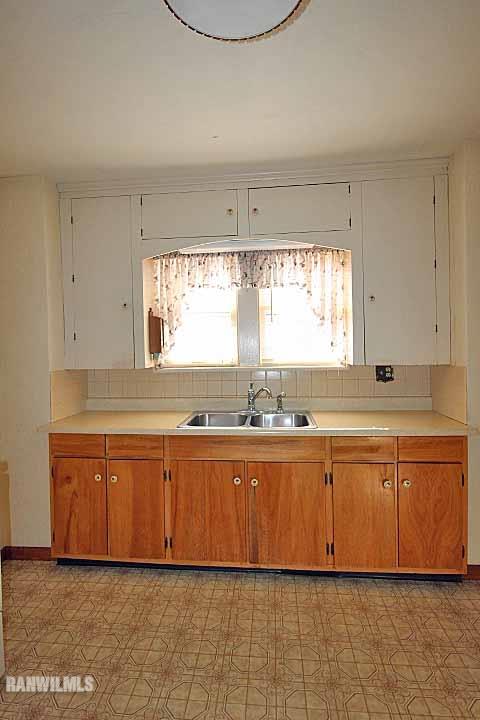 898 North Henderson Road Freeport, IL 61032 - Photo 10 of 19 view of kitchen with granite countertop lots of white stainless steel appliances a sink and a large window