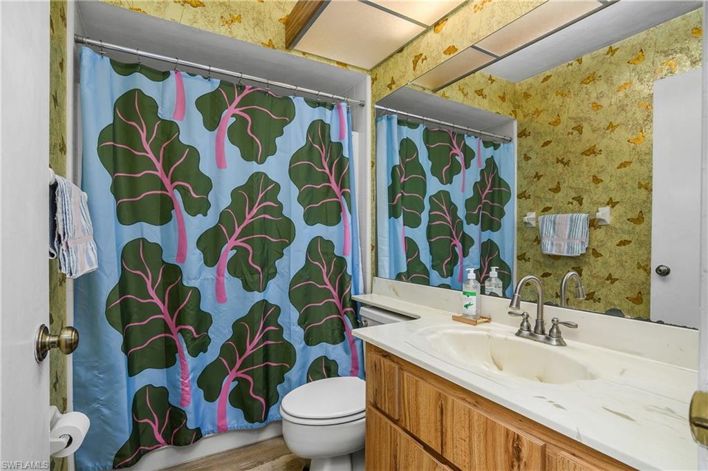 191 Round Key Circle, Unit D2 Naples, FL 34112 - Photo 20 of 24 a bathroom with a sink and a toilet