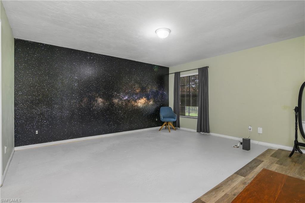 191 Round Key Circle, Unit D2 Naples, FL 34112 - Photo 22 of 24 a view of a livingroom with furniture and a ceiling fan