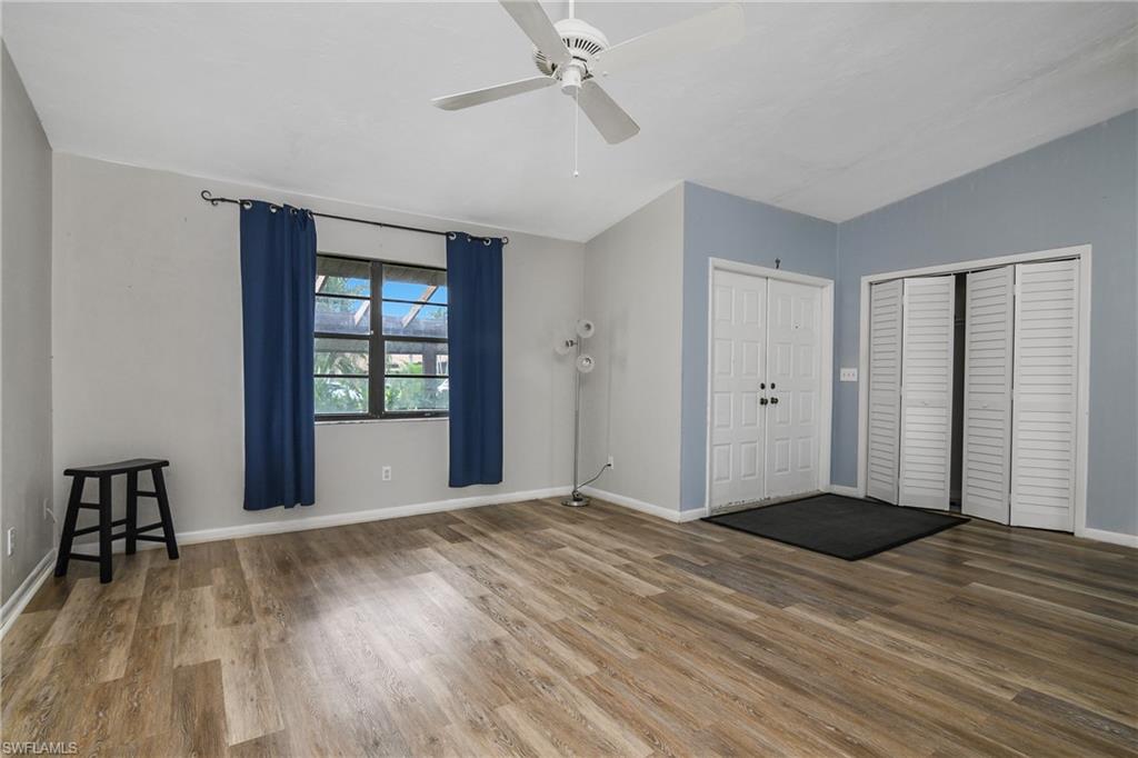 191 Round Key Circle, Unit D2 Naples, FL 34112 - Photo 4 of 24 a view of empty room with wooden floor and fan