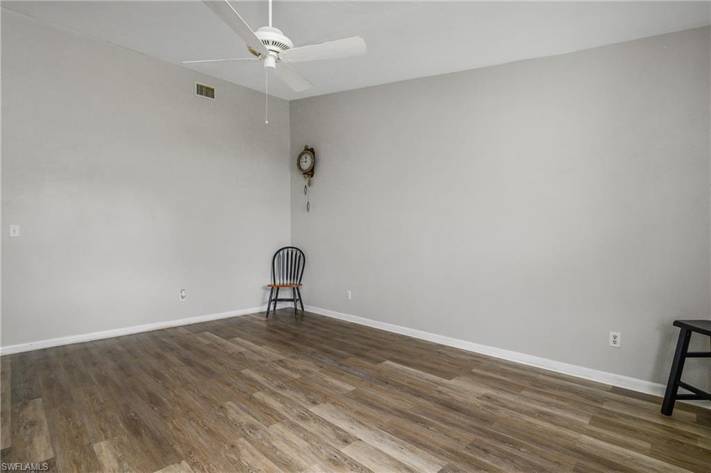 191 Round Key Circle, Unit D2 Naples, FL 34112 - Photo 7 of 24 a view of a room with wooden floor and fan