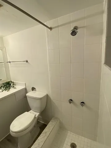 a white toilet sitting next to a bathroom sink