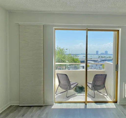 a view of a room that has a bed and a table in it