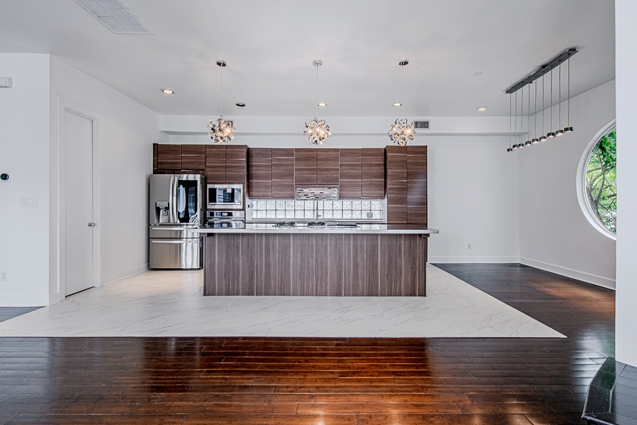 2025 Colquitt Street, Unit E Houston, TX 77098 - Photo 9 of 29 Another view of the kitchen highlighting generous prep space and contemporary finishes.