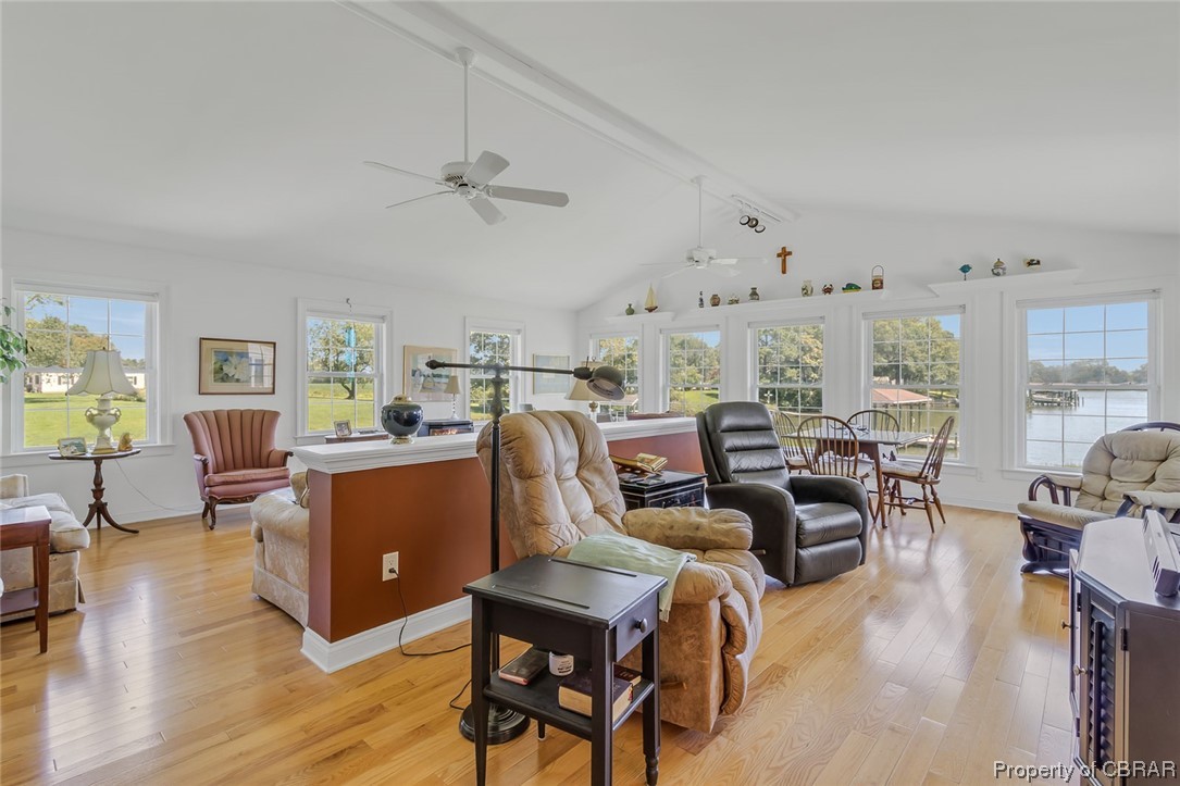 43 Locksley Court Reedville, VA 22539 - Photo 3 of 37 Hardwood floored living room featuring vaulted ceiling with beams and ceiling fan