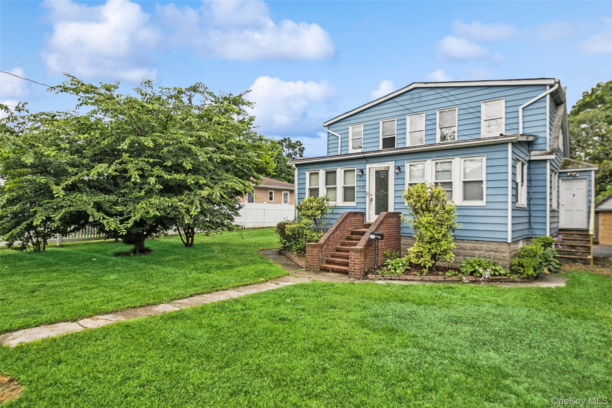 a front view of a house with a garden