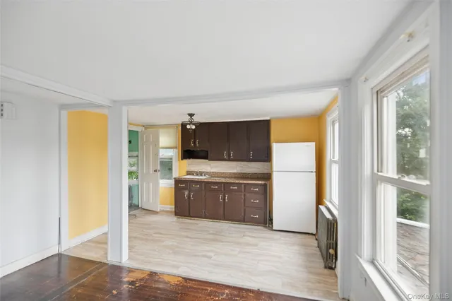 a kitchen with a refrigerator and cabinets