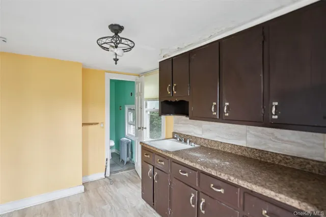 a kitchen with a sink and a refrigerator
