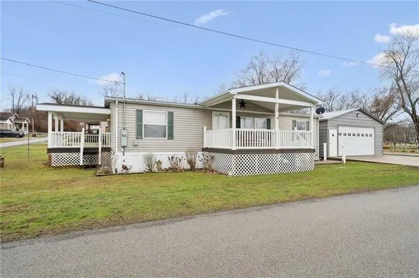 a view of a house with a garden and deck