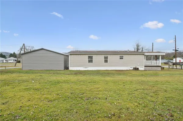 a view of a house with a backyard space and balcony