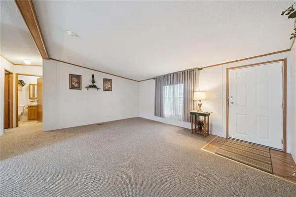 a view of a livingroom with furniture and a window