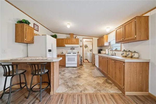 a kitchen with a table chairs refrigerator and cabinets
