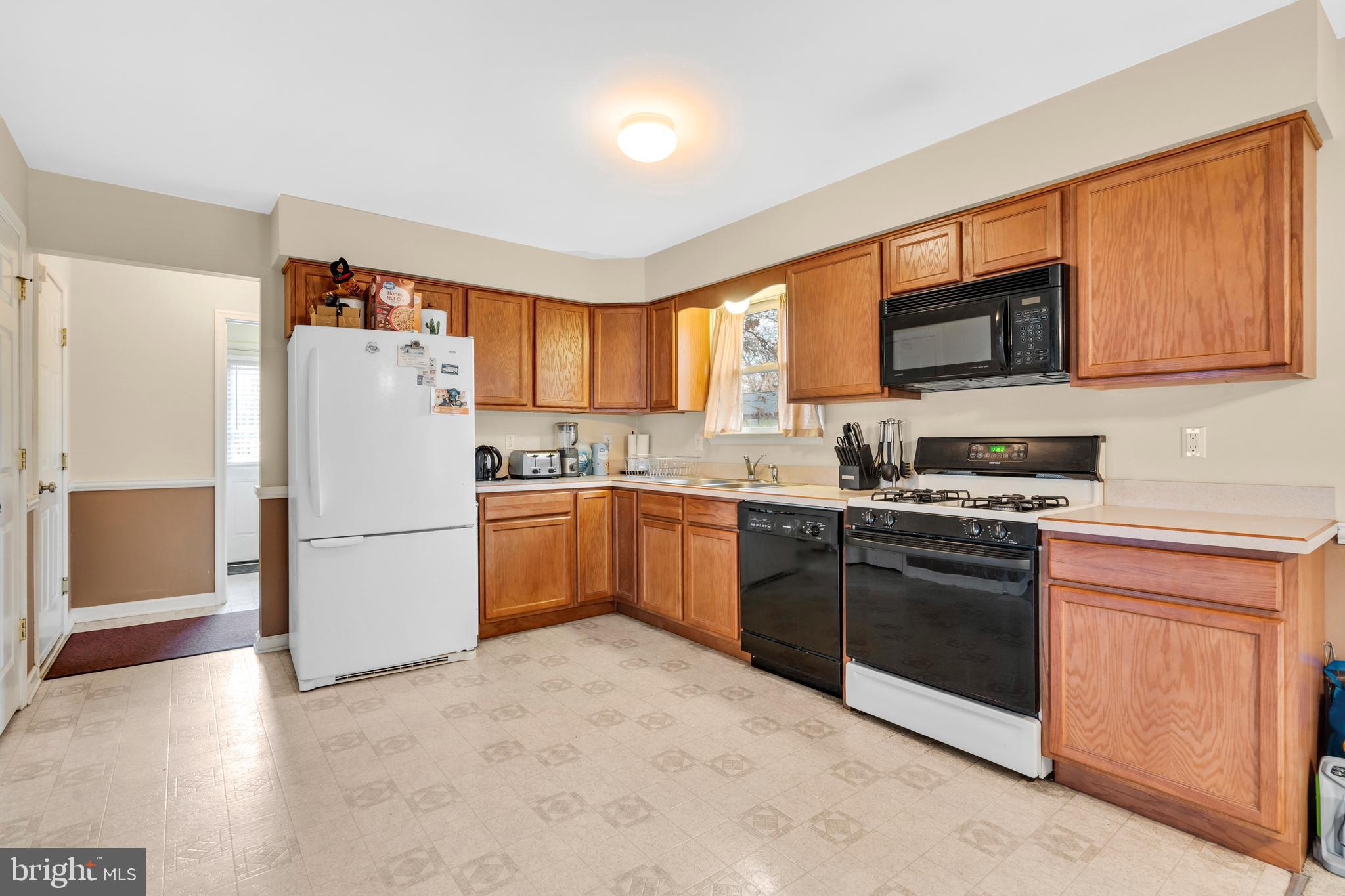 470 Wilson Avenue Lindenwold, NJ 08021 - Photo 2 of 38 a kitchen with a refrigerator stove top oven a sink and dishwasher