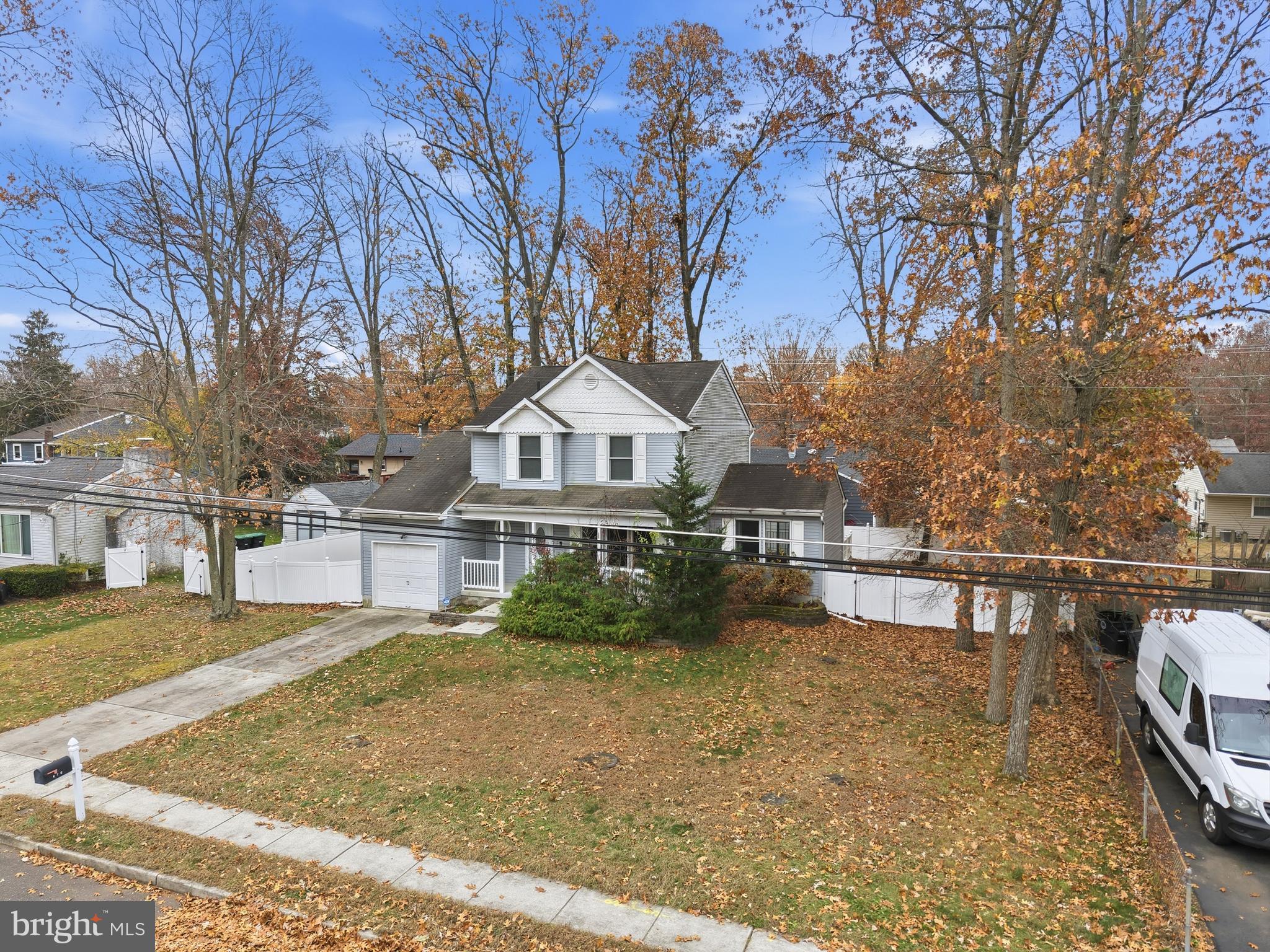 470 Wilson Avenue Lindenwold, NJ 08021 - Photo 36 of 38 a view of a white house next to a yard with large trees