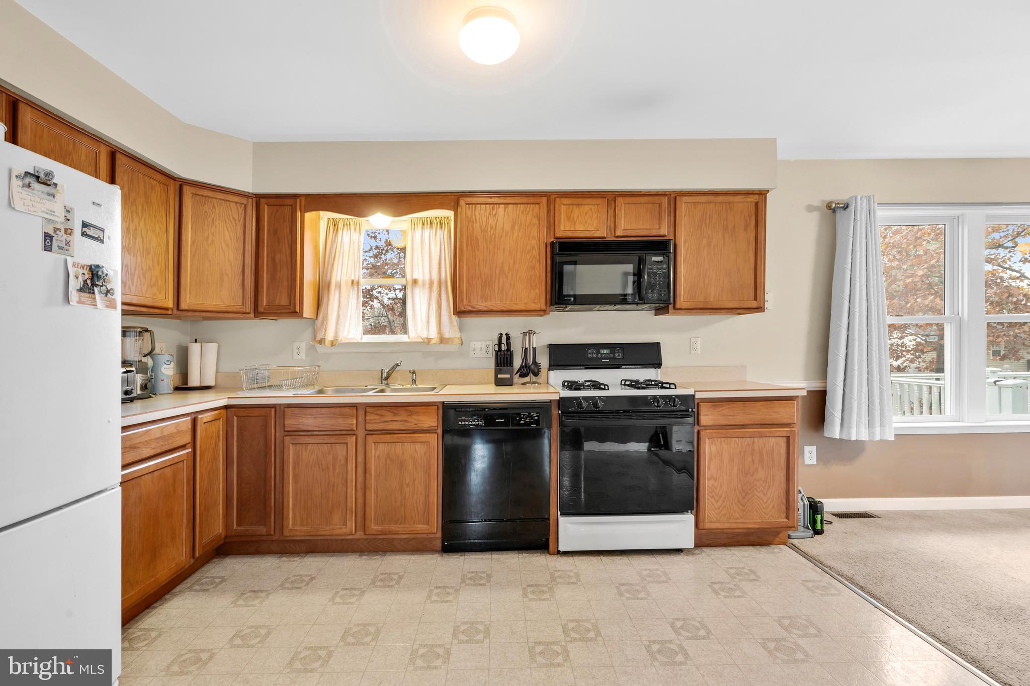 470 Wilson Avenue Lindenwold, NJ 08021 - Photo 4 of 38 a kitchen with stainless steel appliances granite countertop a stove a sink and a microwave