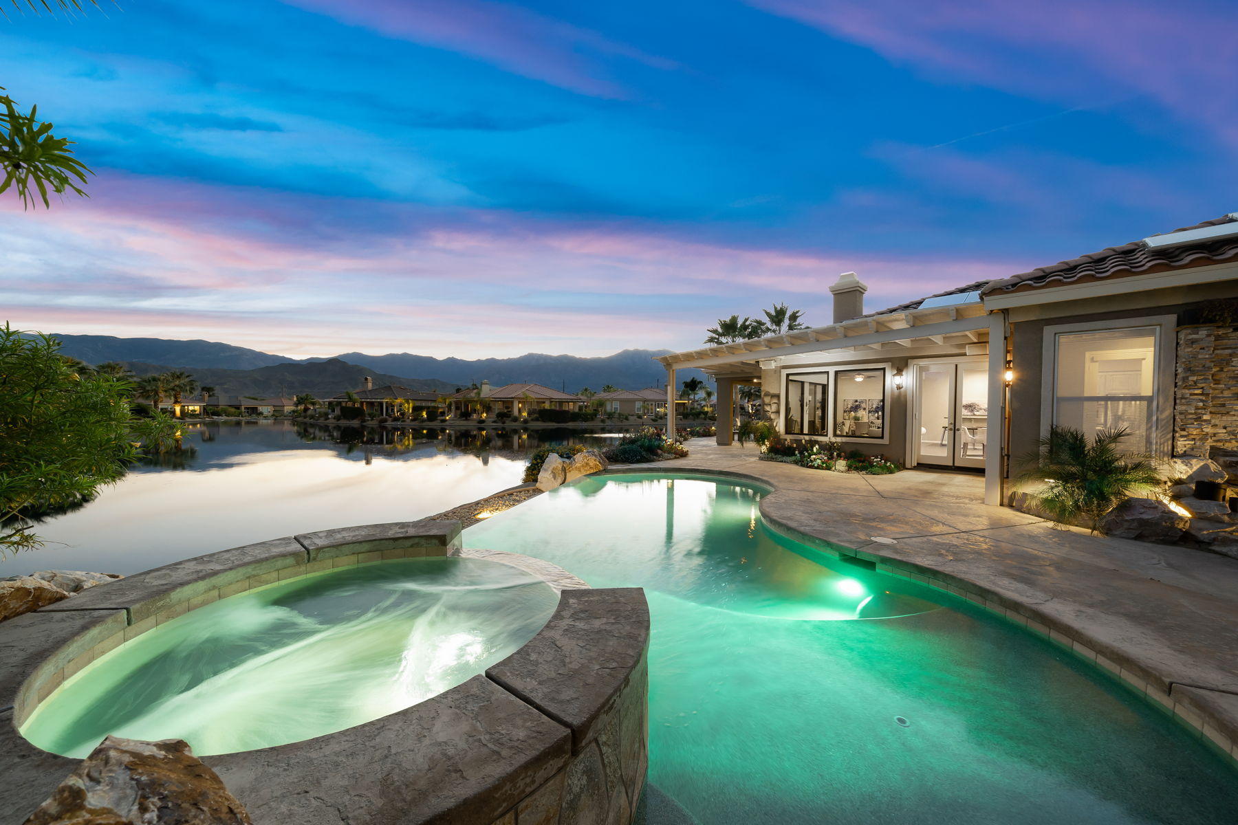 a swimming pool with outdoor seating and yard