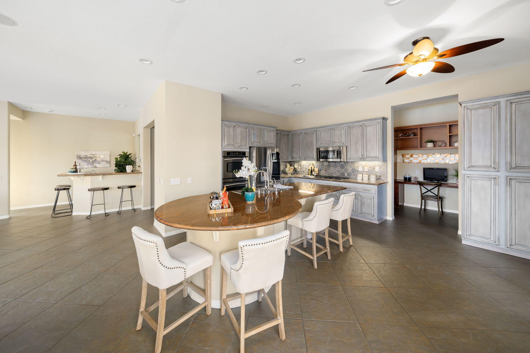 3 Pyramid Lake Court Rancho Mirage, CA 92270 - Photo 16 of 40 a dining room with kitchen island furniture a chandelier and kitchen view