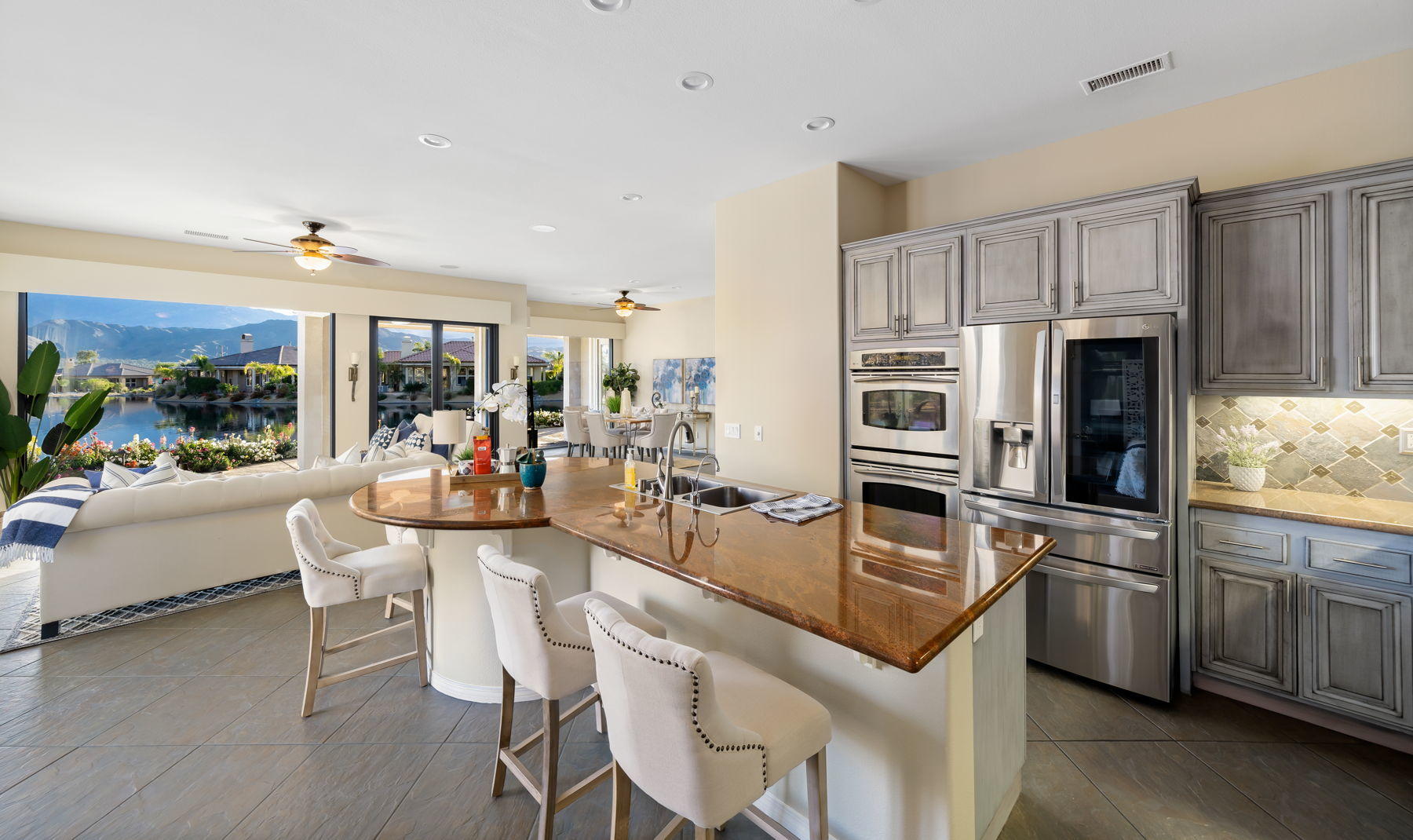 3 Pyramid Lake Court Rancho Mirage, CA 92270 - Photo 17 of 40 a kitchen with stainless steel appliances granite countertop a stove refrigerator and chairs
