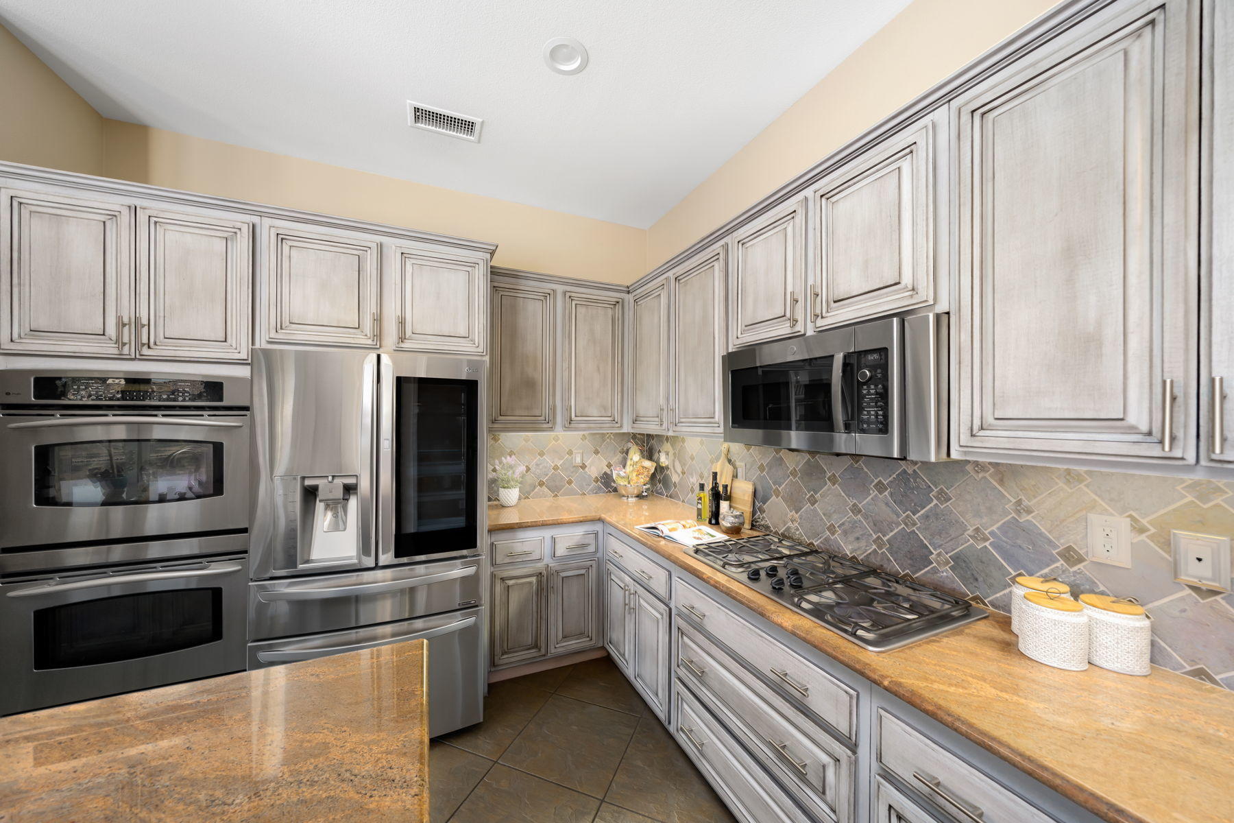 3 Pyramid Lake Court Rancho Mirage, CA 92270 - Photo 19 of 40 a kitchen with stainless steel appliances granite countertop a stove a sink and a refrigerator