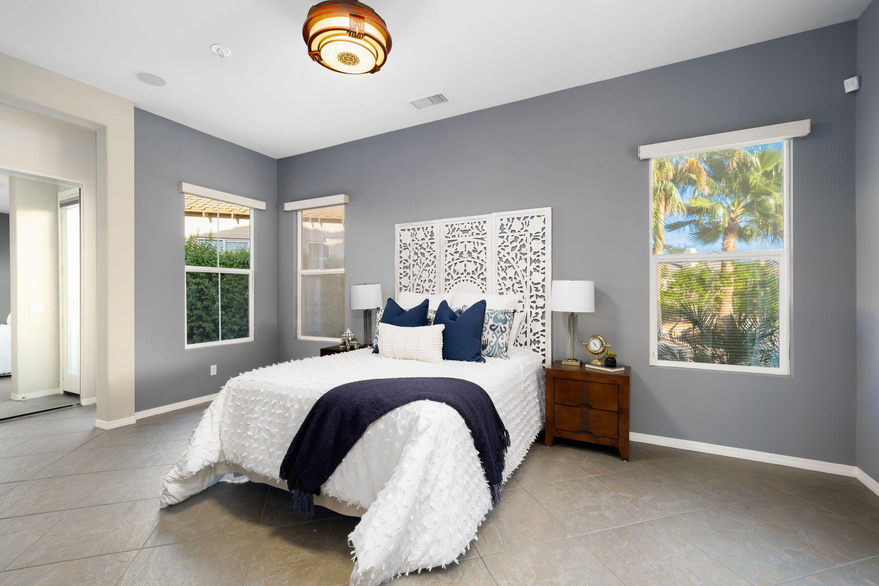 3 Pyramid Lake Court Rancho Mirage, CA 92270 - Photo 21 of 40 a spacious bedroom with a bed and a window
