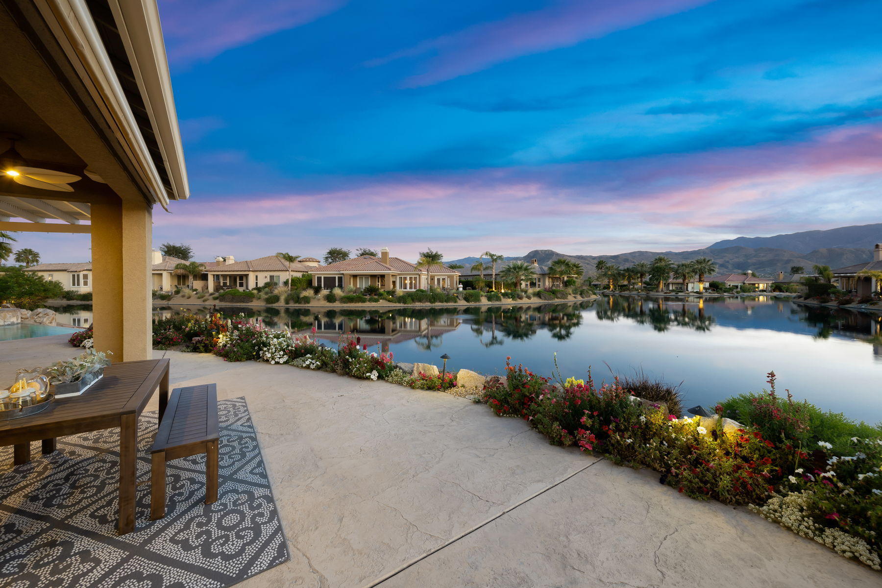 3 Pyramid Lake Court Rancho Mirage, CA 92270 - Photo 34 of 40 a view of a lake with a table under an umbrella