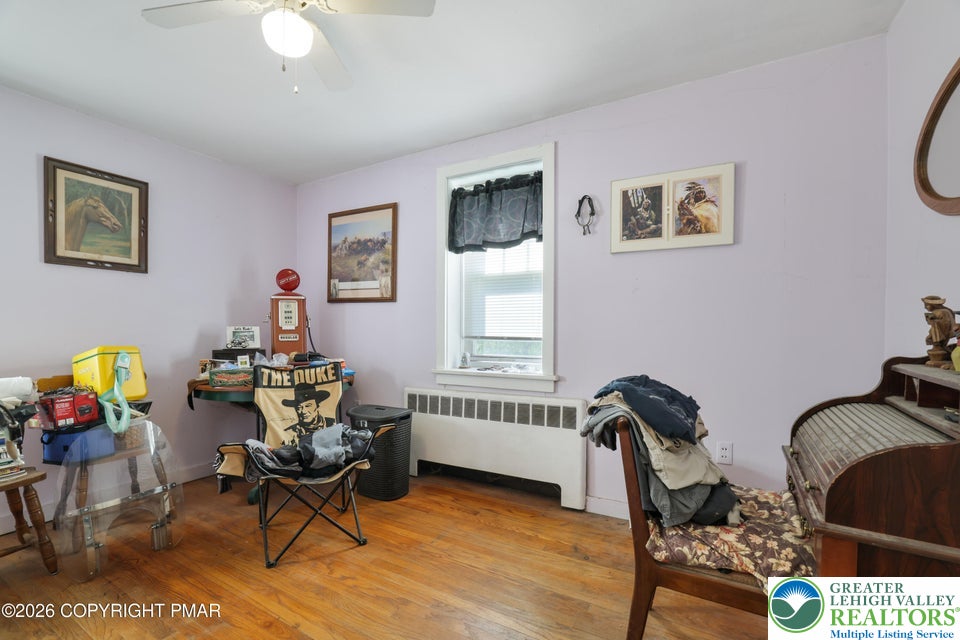 1207 Seese Hill Road Canadensis, PA 18325 - Photo 17 of 49 Warm hardwood flooring and a classic radiator heater anchor this versatile secondary bedroom space.