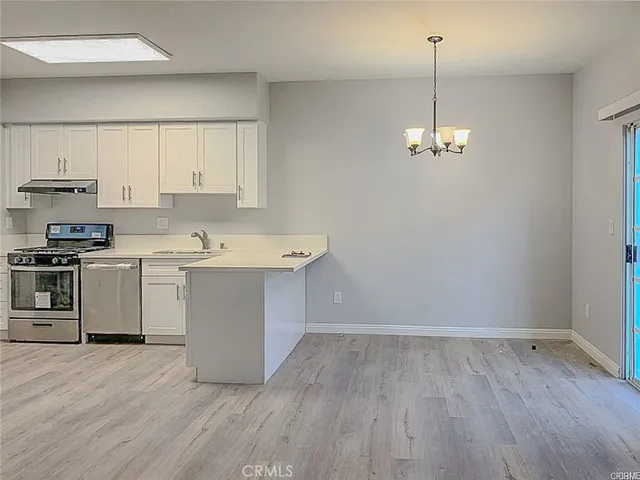 a view of a kitchen with electric appliances